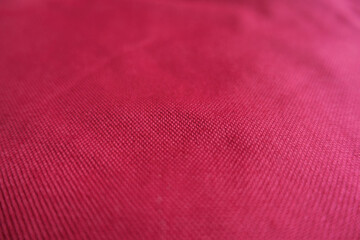 Close shot of ruby red unprinted dense cotton fabric