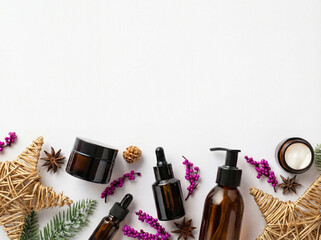 Winter skincare cosmetics concept. Top view photo of glass bottles jars christmas decor wicker stars mistletoe berries and anise on isolated white background