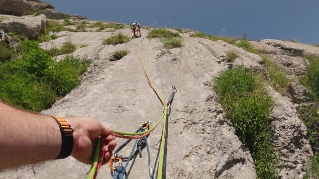 Belayer Giving Slack as Lead Climber Clips Quickdraw - Slow Motion