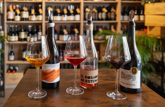 Wine tasting selection with red rose and white wine glasses at wine bar. Valencia, Spain - August 8, 2025.