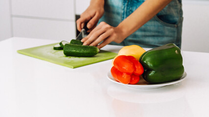 Preparing vegetables for a meal in a kitchen using fresh ingredients and a cutting board