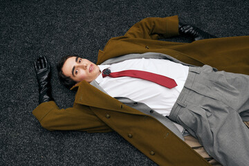 Stylish man showcases modern elegance with a bold fashion statement in a creative setting