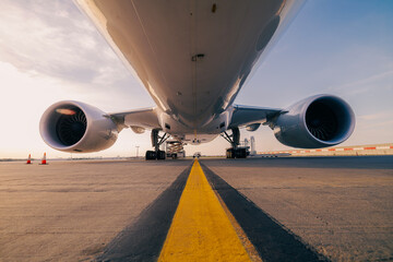 Low angle view of cargo airplane at airport. Preparation freight plane before flight during sunny day.