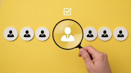 Searching for Talent: a conceptual image of talent search, where a magnifying glass highlights a candidate on a bright yellow backdrop. 