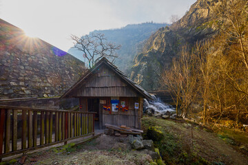 Landscape of the Almaj Valley in Romania, with the watermills of Rudăria and the mountain river.