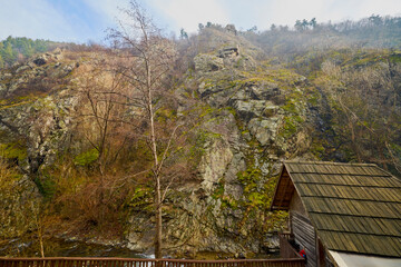 Landscape of the Almaj Valley in Romania, with the watermills of Rudăria and the mountain river.