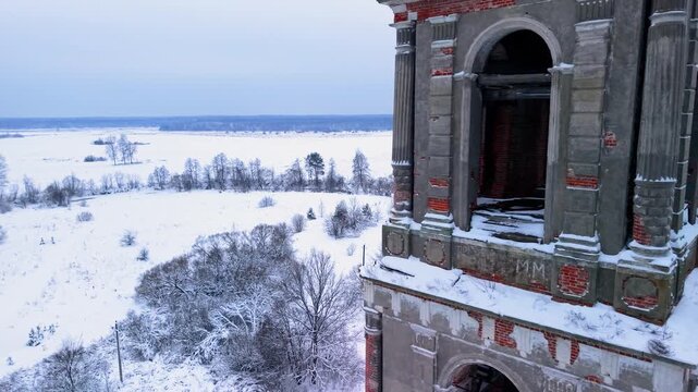 Drone ascends above historic bell tower revealing vast snowy forest horizon, delivering cinematic winter scenery for travel marketing, storytelling, and branding projects