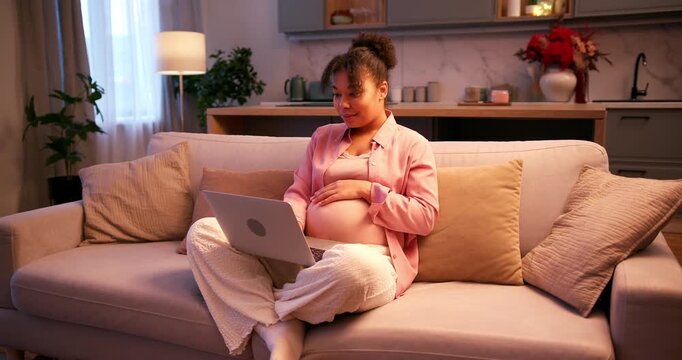 Pregnant african american woman using a laptop