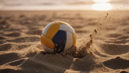 Obraz premium Volleyball resting in the sand on a beach at sunset.