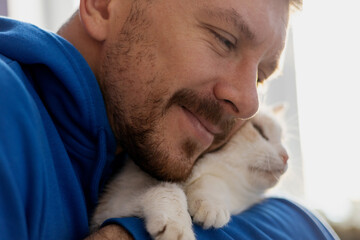 Man with cute cat . Pets and humans friendship, love and trust concept
