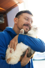 Man with cute cat . Pets and humans friendship, love and trust concept