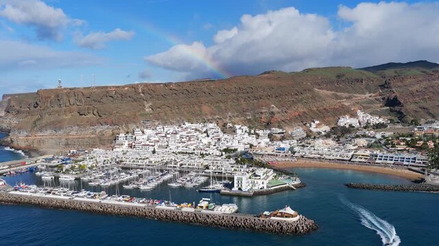 Puerto de Mog&aacute;n Aerial View with Rainbow over the South Coast of Gran Canaria, Canary Islands - 4K Cinematic Shot