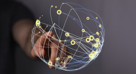Abstract image of a person's hand interacting with a glowing digital network sphere, symbolizing global connectivity, communication a
