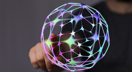 An image of a human hand touching a futuristic, abstract sphere. Concept of global network, connection, innovation, and digital techn