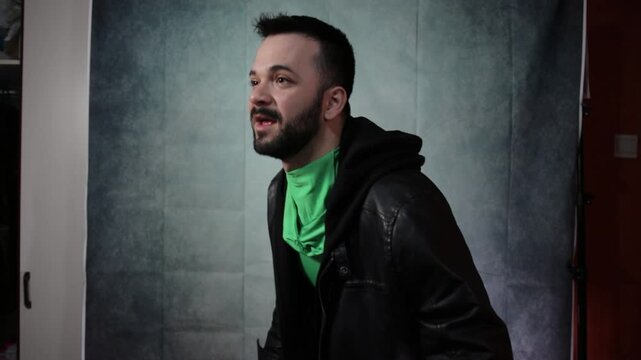 Happy man looking at the camera in a green screen studio.