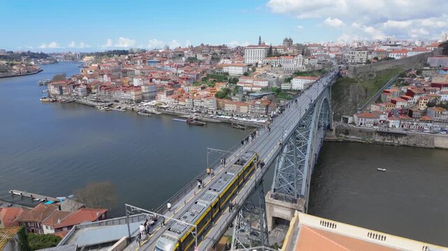 View from Dom Luis I Bridge over Douro River
Perspective from above showing river activity and city connection.