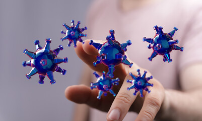 Artistic depiction of Covid-19 cells floating near human fingers. Illustrative virus concept for healthcare an