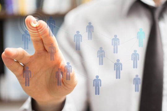 Businessman touching a digital interface representing a human network, connections, and technology. Concept of - Powered by Adobe