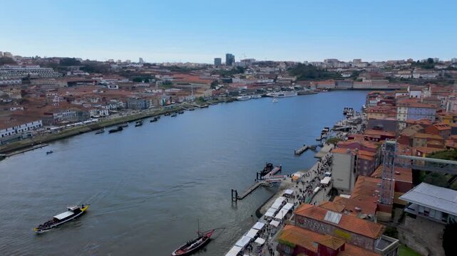 Wide view of Porto skyline and Douro River waterfront
Expansive landscape of the city with historic buildings and river activity.