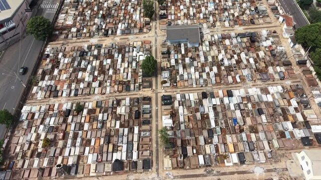 Aerial video footage of a densely populated urban slum with makeshift homes and streets