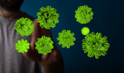 Concept image of a man's hand touching or interacting with floating green viruses or bacteria,...