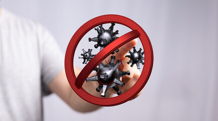 Hand pressing a stop sign on a conceptual coronavirus. Represents prevention and the end of the pandemic. Conc