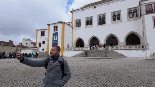 Man walking in front of historic building in Lisbon
Person passing by a traditional Portuguese building with classic architecture and urban setting.