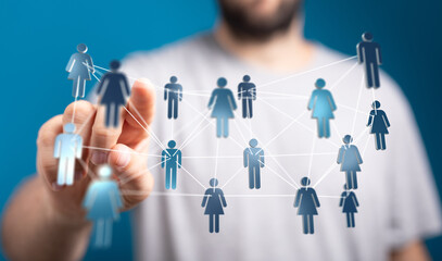 Hand reaching towards a network of connected human icons symbolizing connectivity, relationships, teamwork, and