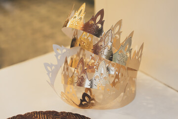 Golden crowns and French galette des rois in a bakery window on the French feast of Saint Epiphany