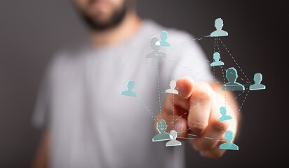 Concept image of a man's finger interacting with a digital network, representing social...