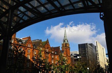 Fototapeta premium Urban skyline contrasting old new architecture under blue sky