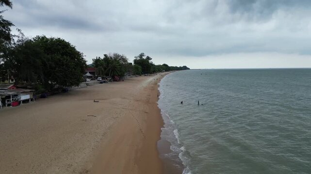A beach with a red building in the background. Aerial view Tanjong Bidara, Melaka