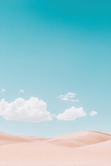 Vast desert landscape with soft sand dunes under a clear blue sky with fluffy white clouds.