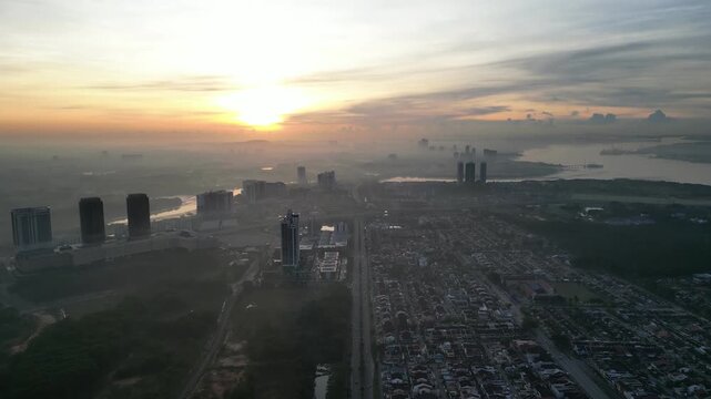 Larkin city with a large building in the middle and a river in the background. Aerial view