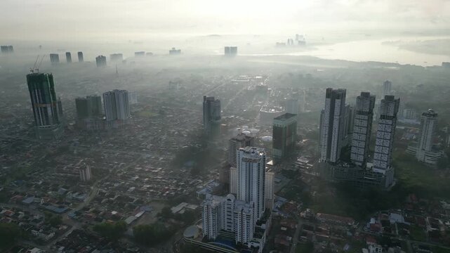 The city is covered in a thick layer of fog, making it difficult to see the buildings clearly.. Aerial view Larkin, Johor