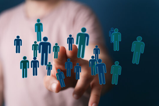 Hand pointing at human silhouettes representing people, connections, communication, community, and business ide