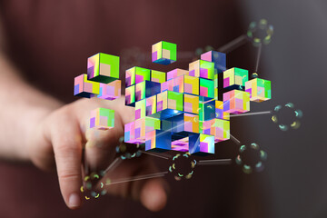 Hand reaching towards a network of colorful cubes symbolizing digital connectivity and innovation. Concept of m