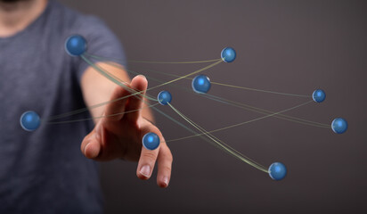 Abstract image depicting human hand connecting with spheres, representing a network or data. Ideal for technolo