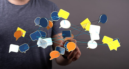 A man's hand interacting with connected message bubbles, representing communication, sharing ideas and social c