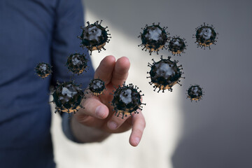 Abstract conceptual image of a human hand interacting with floating coronavirus cells, representing the threat