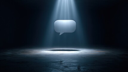 Light shines on a speech bubble in a dark space creating a focal point for communication and expression