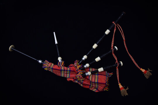 Scottish Great Highland bagpipes on a black background