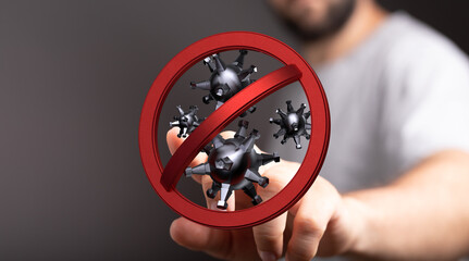 Concept image of a man's hand holding a sign symbolizing stopping the spread of viruses and infections. Focus