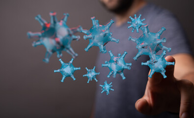 Visual representation of the coronavirus pandemic, featuring a person interacting with digital 3D virus models