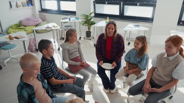 Children sitting in a morning circle with their teacher before class starts.