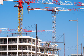 Wide tower crane cables above construction site and building development showing architecture urban engineering infrastructure property project