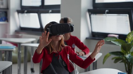 Elementary school students using virual reality in classroom. - Powered by Adobe