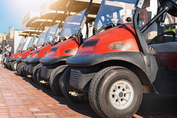 Golf carts lined up on a bright day at a luxury golf course near the clubhouse © Sergey