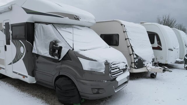 4K: Caravans & Motorhomes parked up for WInter Storage with Snow and Ice on the windows. Stock Video Clip Footage