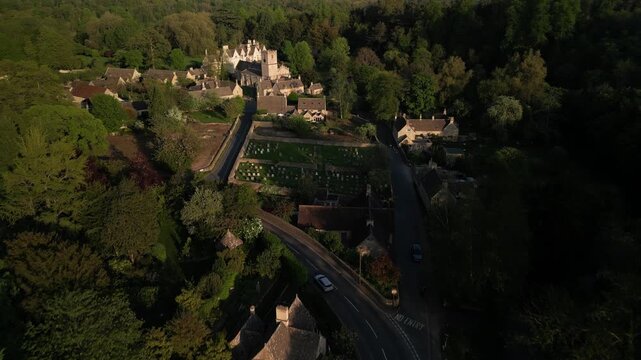 Village in rural England on a sunny evening - aerial footage